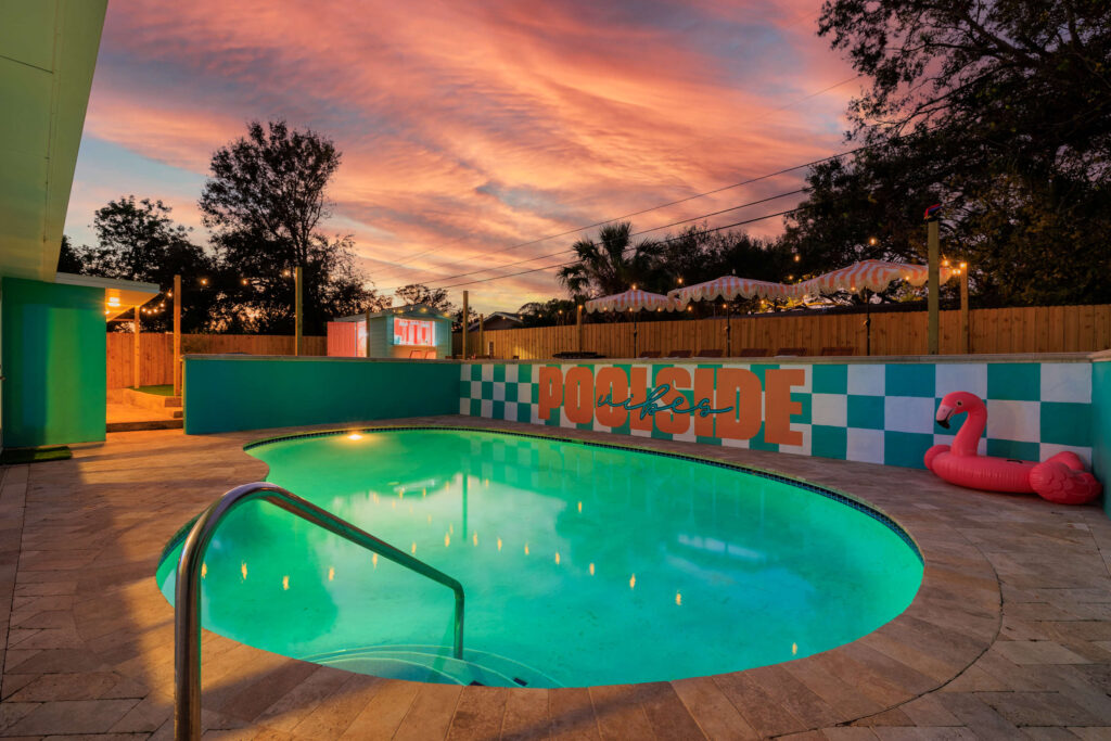 Colorful poolside at sunset with flamingo
